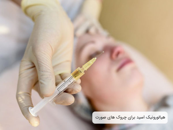 تصویر خانمی خوابیده روی تخت در حال تزریق ژل برای چروک های صورت است ، لباس پزشک و زمینه تصویر سفید می باشد