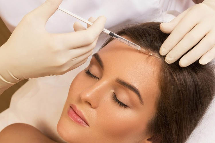 انجام مزوتراپی مو روی سر یک خانم جوان توسط پزشک.