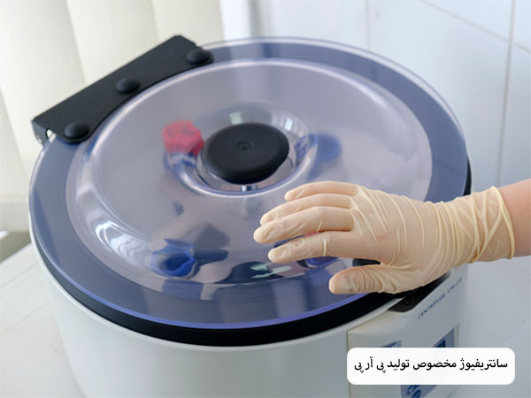 سانتریفیوژ prp که پزشکی دستش را روی آن قرار داده است.